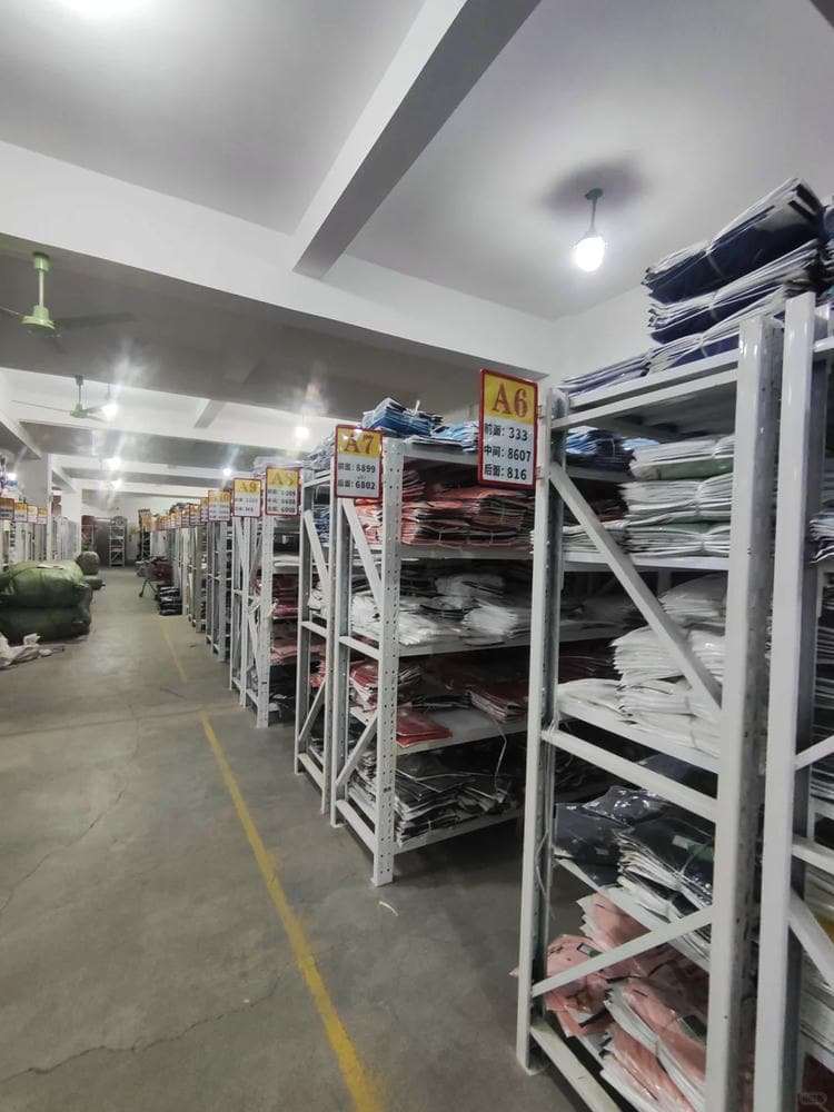 wholesale t-shirts warehouse storage bulk inventory stacked